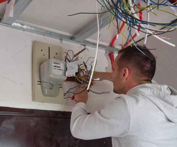 Electrician technician at work on electric installation