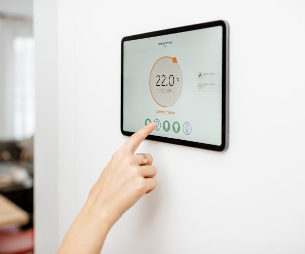 Woman controlling heating with a smart devices